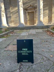 Placard offering "Free Community meal for the people of East London"